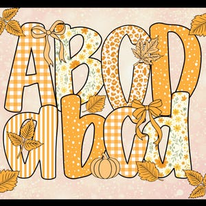 May include: A decorative fall-themed design featuring the letters A, B, C, and D in a playful font. The letters are filled with patterns like gingham, floral, and leopard print, accented with bows, leaves, and a pumpkin. The background is a soft pink with a speckled effect.