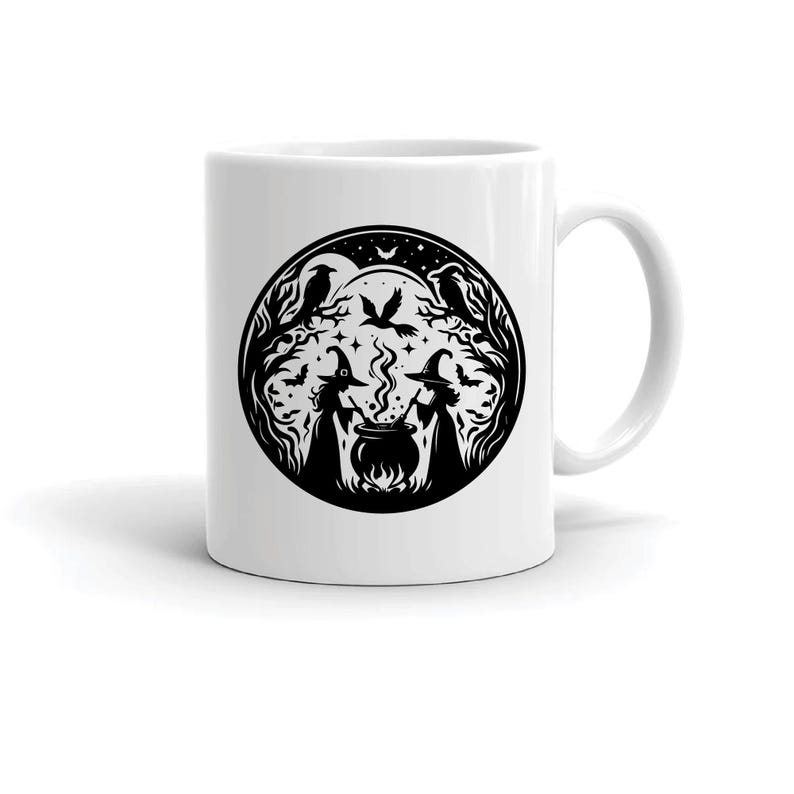 May include: White ceramic mug with a black and white illustration of two witches stirring a cauldron in a forest setting. The illustration includes ravens, stars, and a full moon.