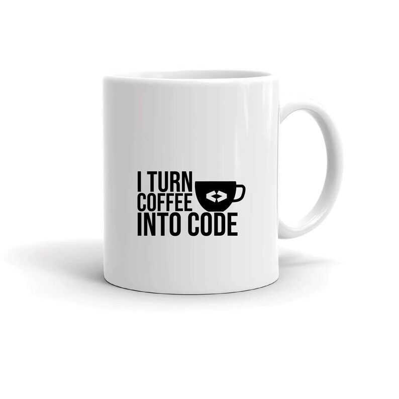 May include: White ceramic coffee mug with a black graphic that reads "I TURN COFFEE INTO CODE." The design includes a coffee cup icon with a circular arrow. The mug has a curved handle and is suitable for hot beverages.