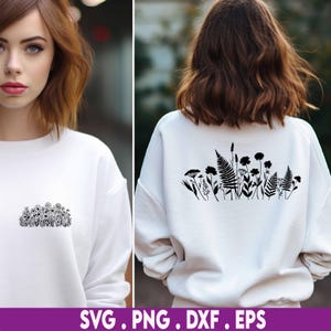 May include: White sweatshirt with a black floral design on the front and back. The front design is a cluster of various flowers, while the back showcases a larger arrangement of ferns and wildflowers. The bottom of the image displays the text "SVG . PNG . DXF . EPS".