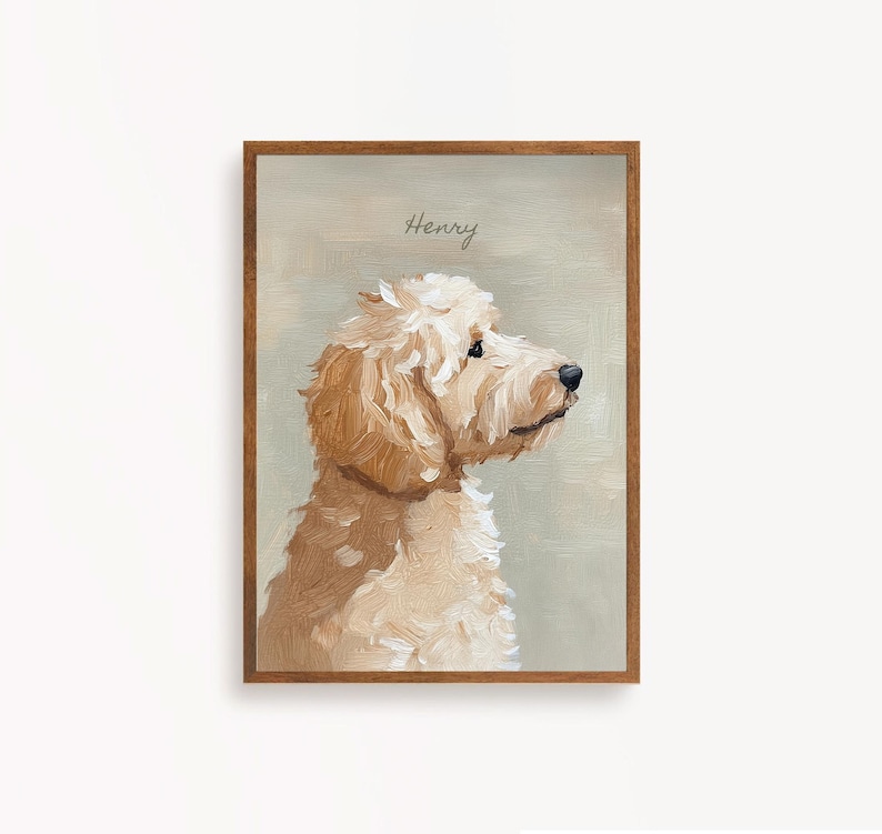May include: A framed portrait of a golden doodle dog in profile. The dog has fluffy, light brown fur and a black nose. The name "Henry" is written in cursive at the top. The frame is a dark brown color.
