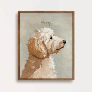 May include: A framed portrait of a Goldendoodle dog in profile, painted in shades of cream and brown. The dog's name, "Henry," is written above in cursive. The artwork is set against a muted green background.