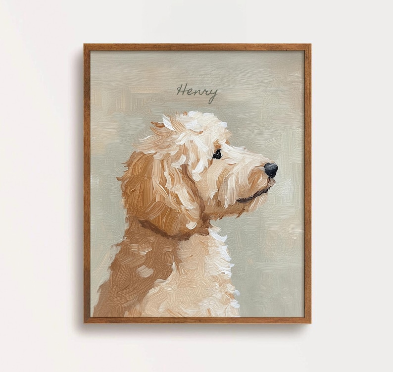 May include: A framed portrait of a Goldendoodle dog in profile, painted in shades of cream and brown. The dog's name, "Henry," is written above in cursive. The artwork is set against a muted green background.