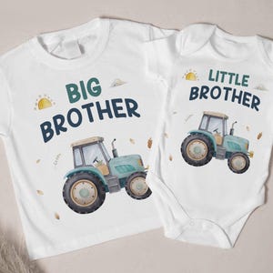 Puede incluir: Dos camisetas blancas con un diseño de tractor y el texto "Hermano Mayor" y "Hermano Menor".