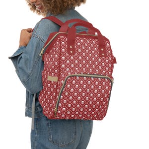 Multifunctionele rugzak met wit doodskopmotief en rode accenten | Verschoontas voor baby's