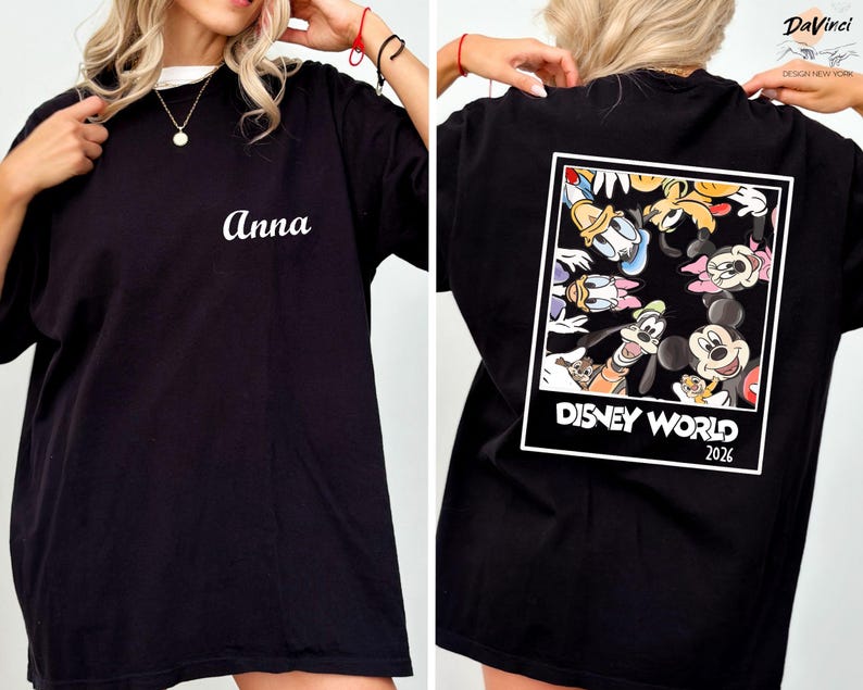 a person wearing a black t-shirt with a Disney World-themed design on the back.