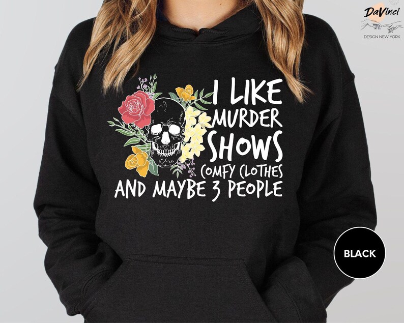 a woman wearing a black hoodie that says i like murder shows and maybe 3