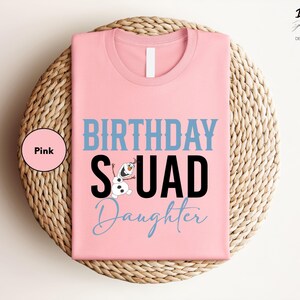 a pink birthday squad shirt sitting on top of a wicker basket