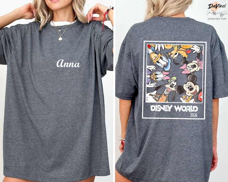 a woman wearing a gray t-shirt with a Disney World logo and text on the back.