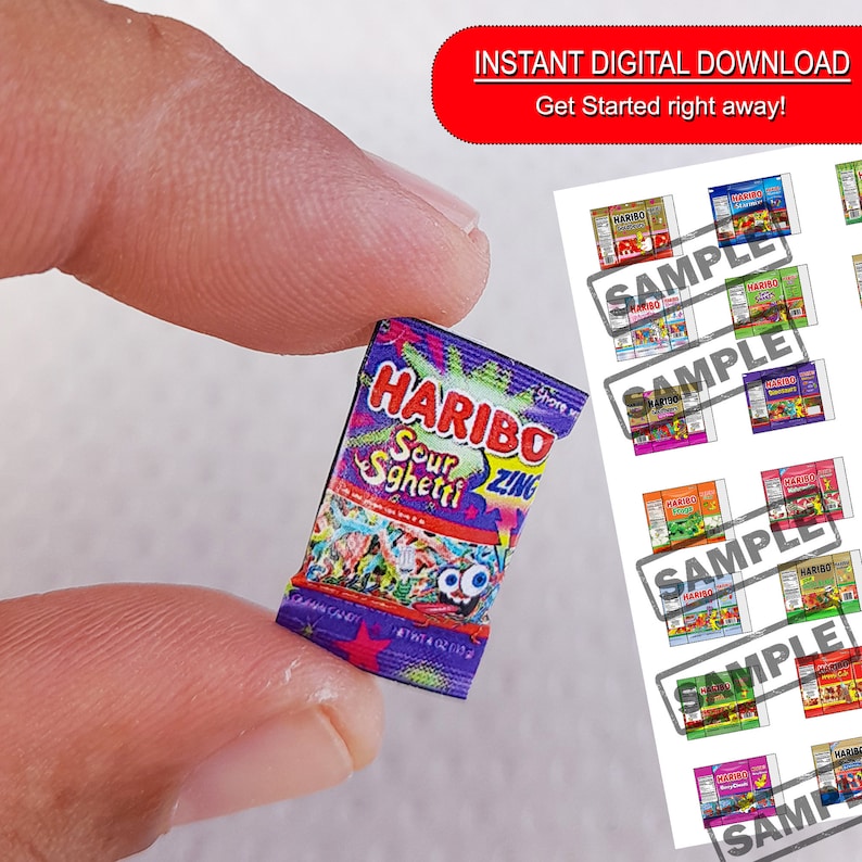 May include: A miniature package of Haribo Sour Sgheti Zing gummy candies. The package is purple and features a cartoon image of gummy worms. The text on the package reads "Haribo Sour Sgheti Zing".