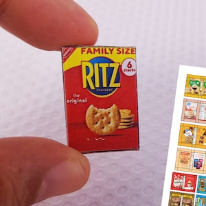 May include: A red and white box of Ritz crackers, family size, with 6 stacks of crackers. The box says "The Original" and features a picture of Ritz crackers.