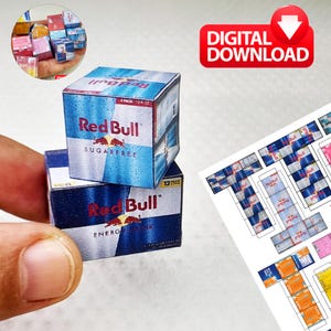 May include: Miniature Red Bull energy drink boxes, one sugar-free, stacked on top of each other. The boxes are blue and white with the Red Bull logo. The image also includes a "DIGITAL DOWNLOAD" graphic.