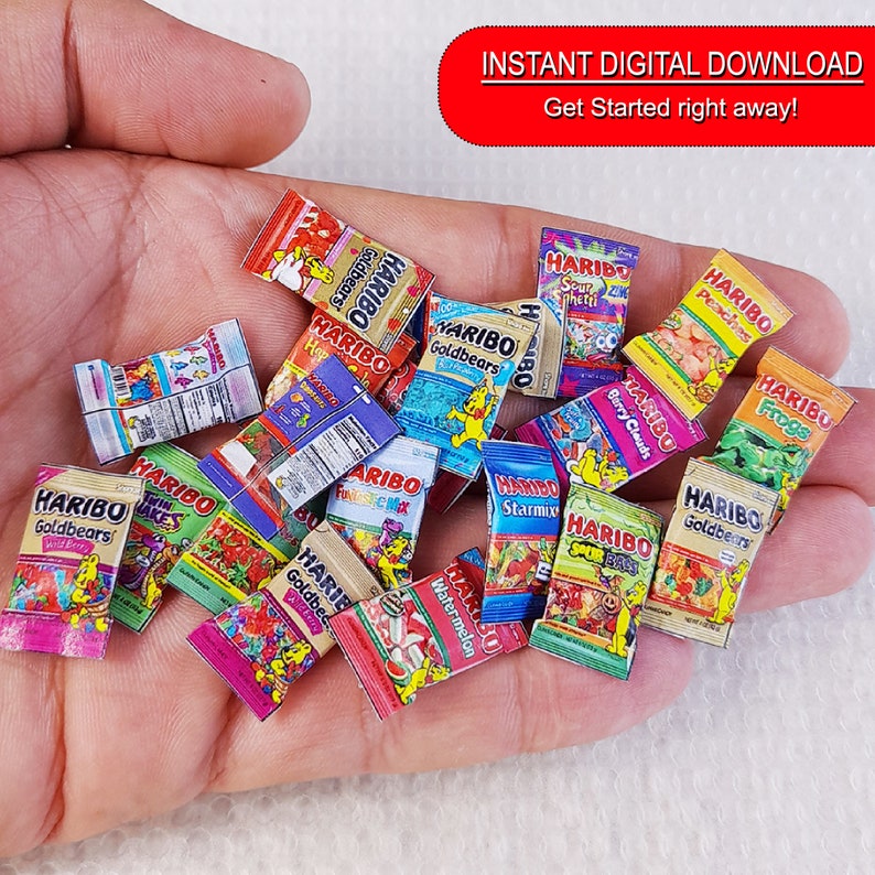 May include: Assortment of miniature HARIBO gummy candy bags. The bags feature various flavors, including Goldbears, Twin Snakes, Sour Mix, Starmix, Berry Clouds, Peaches, Frogs, Watermelon, and Sour Spray. The bags are printed with colorful graphics and the HARIBO logo.