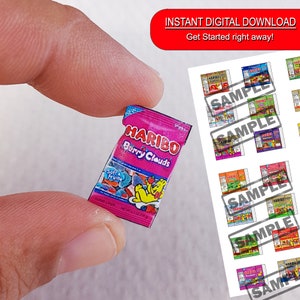 May include: A miniature pink and purple bag of Haribo Berry Clouds candy. The bag has a picture of a bear and the text "Haribo Berry Clouds" and "Soft & Fruity".