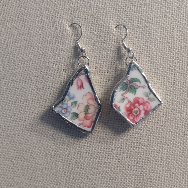 E180- Broken china earrings framed in silver-tone solder on French wire hooks.