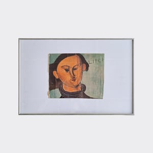 May include: A framed portrait of a person with dark hair and a black collar. The artwork is a painting with a muted color palette, featuring a light skin tone and the word "LIPCH" in the upper right corner.