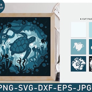 May include: A 3D layered laser cut design of a sea turtle swimming in a blue ocean with coral and seaweed. The design is framed in a wooden frame and is ready to be assembled.