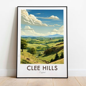 May include: A vintage travel poster featuring a scenic view of Clee Hills in England. The poster has a blue sky with white clouds, green hills, and a winding road. The text "CLEE HILLS" and "England" is printed in black at the bottom of the poster.
