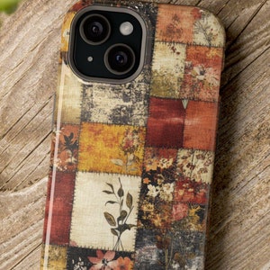 May include: A phone case with a patchwork design featuring a variety of colors and patterns, including red, orange, yellow, green, and brown. The case has a floral design and a camera lens cutout.