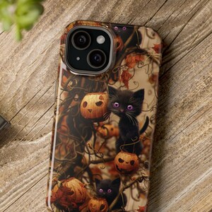 May include: A black iPhone case with a Halloween theme. The case features black cats, jack-o'-lanterns, and autumn leaves on a brown background.
