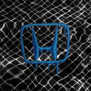 May include: A blue embroidered Honda logo with a dripping effect, set against a black and white patterned background. The logo is a stylized 'H' shape, with a textured appearance, suggesting a patch or emblem.