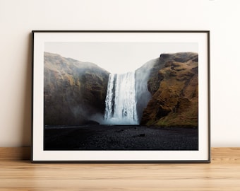 May include: A dramatic black and white photograph of a waterfall cascading down a rocky cliff face. The waterfall is surrounded by mist and fog, creating a sense of mystery and wonder.