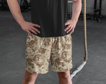 May include: A black t-shirt and camouflage print shorts. The shorts are a light brown and beige color with a camouflage pattern.