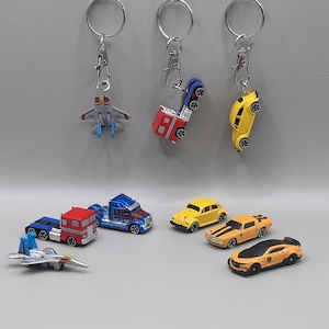 Brelok Transformers w pudełku prezentowym, Autoboty i Decepticony