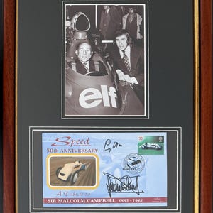 May include: Framed black and white photograph and commemorative stamp. The photograph shows two men in a race car. The stamp commemorates the 50th anniversary of Speed, with a picture of a race car and the text "A Tribute to Sir Malcolm Campbell 1885-1948."