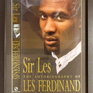 Les Ferdinand Newcastle Utd, England Legend Genuine Hand Signed and Framed (12 X 8 inch) Book Cover With Certificate Of Authenticity (COA).