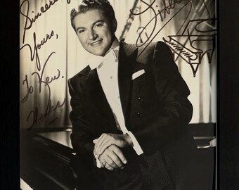 Liberace, Entertainer, Pianist, 100% Guaranteed Hand Signed Photo Presentation, Framed 25cm x 20cm - With COA - Certificate Of Authenticity.