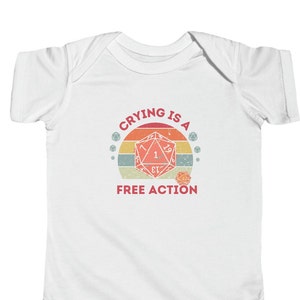 May include: White babygrow with a retro-style graphic of a 20-sided die with the text "Crying is a Free Action".