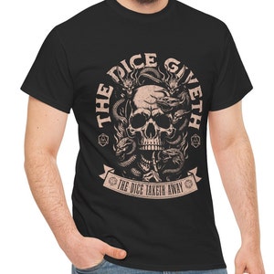May include: Black t-shirt with a graphic of a skull surrounded by snakes and flames. The text "The Dice Giveth The Dice Taketh Away" is printed on a banner below the skull.