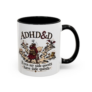 May include: A white ceramic mug with a black interior and handle, featuring a colourful illustration of a traveller looking at a map at a crossroads. The text reads ADHD&D at the top and Even my side quests have side quests at the bottom.