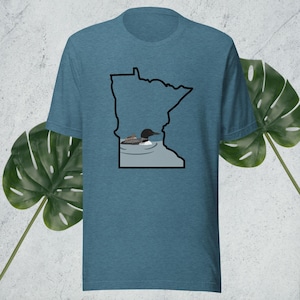 May include: A teal blue t-shirt featuring a black outline of the state of Minnesota with a loon swimming in a lake within the outline.