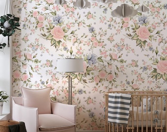 May include: A nursery room with a white floral wallpaper featuring pink roses and gray polka dots. A pink armchair, a wooden crib with a striped blanket, and a floor lamp are in the room. Paper clouds hang from the ceiling.