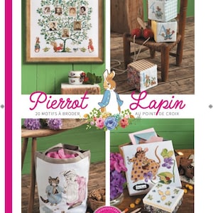 May include: A magazine cover featuring illustrations of Peter Rabbit and other characters from Beatrix Potter's stories. The cover is green and features the title "Pierrot Lapin" in large, white letters. The magazine is for cross-stitch projects.