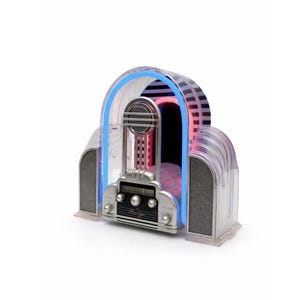 May include: A retro-style jukebox with a clear plastic casing and silver accents. The jukebox features a blue neon light outlining the top and a red neon light inside. It has a speaker on each side and a control panel with knobs.