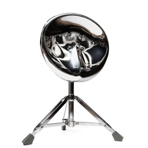 May include: A silver drum throne with a round, chrome-plated seat and a three-legged base.