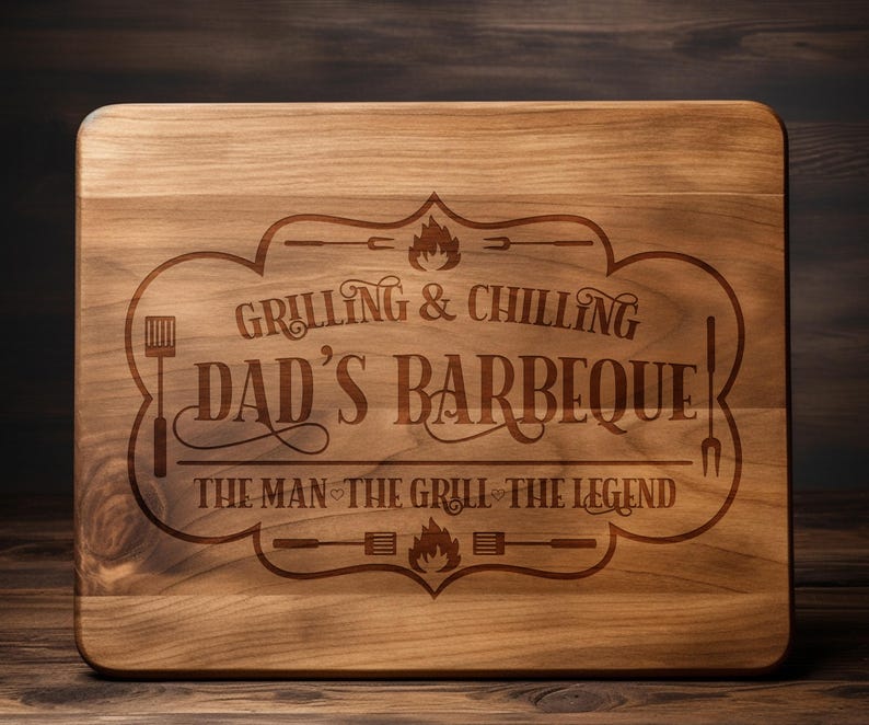 May include: A wooden cutting board with an engraved design that says "Grilling & Chilling Dad's Barbeque The Man The Grill The Legend".