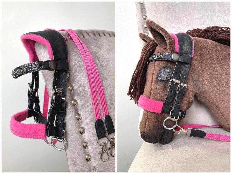 May include: A black bridle with bright pink fleece padding and a browband featuring dark gray crystals. The bridle includes adjustable metal buckles, silver-toned hardware, and long pink reins with black leather ends and metal swivel snap hooks.