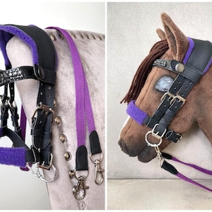 May include: A black leather horse bridle featuring vibrant purple fleece padding on the crown piece and noseband. The browband is embellished with clear crystals. The set includes a matching purple woven rein with silver-toned metal clips.