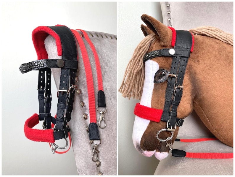 May include: A black leather horse bridle featuring bright red fleece padding on the crown piece and noseband, a browband with embedded crystals, silver-toned metal buckles, and a pair of long red nylon reins with metal swivel snap hooks.