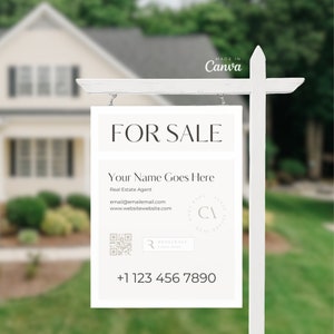 以下が含まれることがあります： 「FOR SALE」と黒文字で書かれた白い不動産看板。看板には、「Your Name Goes Here」、「Real Estate Agent」、「email@emailemail.com」、「www.websitewebsite.com」、QRコード、電話番号（+1 123 456 7890）も記載されています。