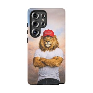 May include: A phone case featuring a lion with a human body wearing a white t-shirt, blue jeans, and a red cap with the text "MAKE AMERICA GREAT AGAIN". The background has a cloudy sky.