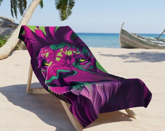 May include: A beach towel featuring a vibrant lion design in shades of purple, green, and pink. The towel is draped over a wooden beach chair on a sandy beach with a boat in the background. The lion's eyes are a bright yellow.