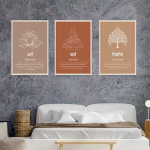 May include: Three framed prints with a light brown background and white illustrations. The first print features a lotus flower with the word "धर्म [dharma]" below it. The second print features a seated Buddha with the word "कर्म [karma]" below it. The third print features a tree with the word "निर्वाण [nirvana]" below it.
