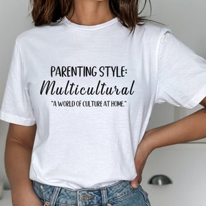 May include: White t-shirt with black text that reads "Parenting Style: Multicultural "A world of culture at home."
