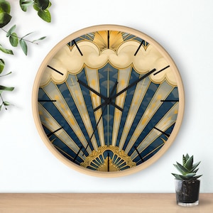 May include: A round clock with a blue and gold design. The clock face features a stylised sunburst pattern with gold accents and a blue background. The clock hands are black.