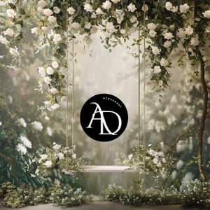 May include: A white swing hanging from a floral archway with white flowers. The swing is made of wood and has a white rope. The background is a blurred image of a garden with green leaves and white flowers.